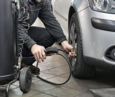 man-in-black-jacket-and-black-pants-sitting-near-silver-vehicle-3807386/