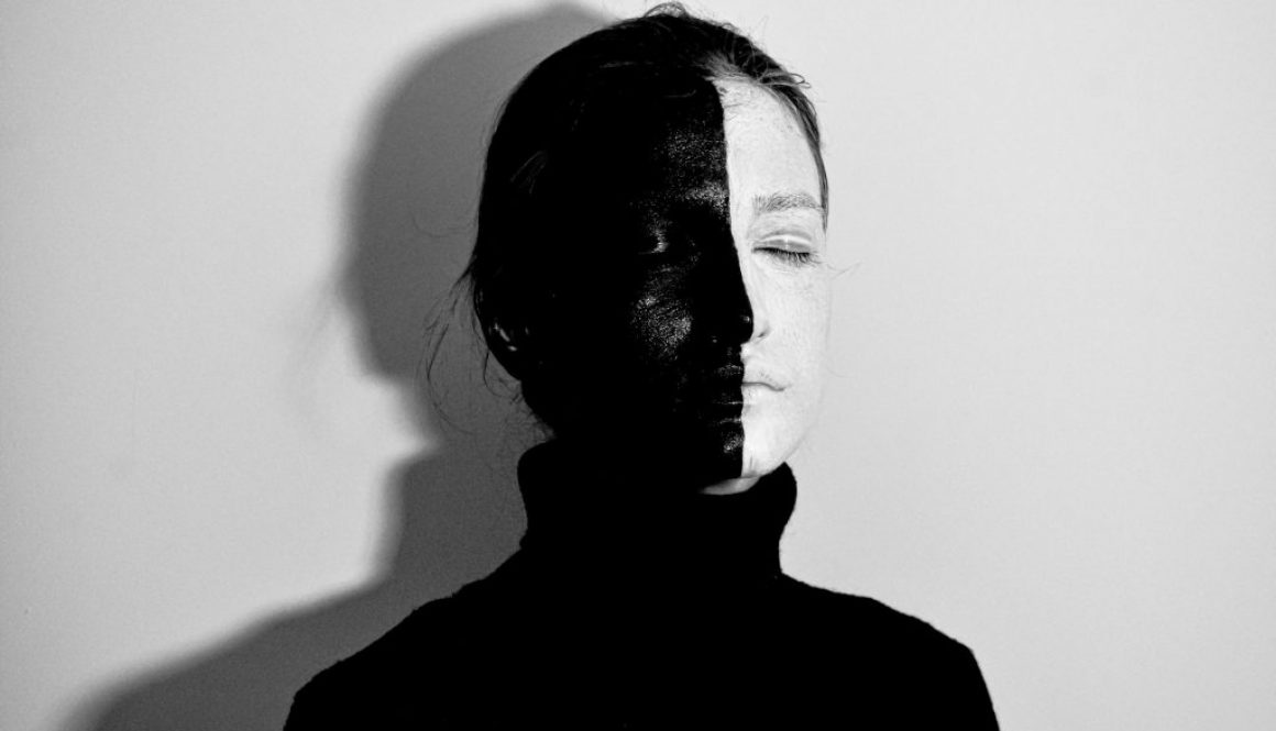 emale-with-face-painted-hand-in-black-and-half-in-white-5785494/