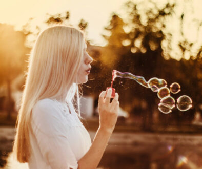 woman-blowing-bubbles-during-sunset-alkJl-mokOY